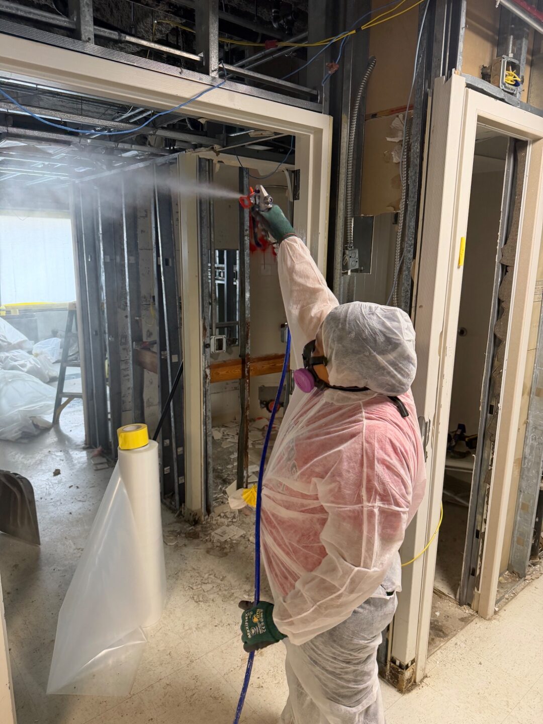 Technician applying encapsulant and biocide treatment